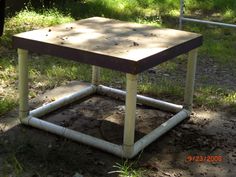 an old wooden table sitting in the dirt