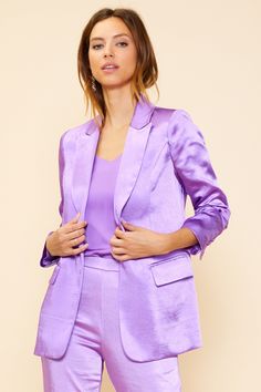 Elevate your look with our luxurious long sleeve satin blazer. Featuring a unique light purple hue, this blazer is made of a satin finish with a lightly lined interior. With classic detailing like flap front pockets and one button closure, you're sure to impress with this timeless, yet modern, style. Formal Purple Outerwear For Spring, Purple Formal Outerwear For Spring, Silk Blazer With Notch Lapel For Spring, Semi-formal Single Breasted Satin Blazer, Elegant Long Sleeve Lavender Blazer, Elegant Lavender Long-sleeve Blazer, Elegant Lavender Long Sleeve Blazer, Chic Purple Blazer With Notch Lapel, Purple Notch Lapel Blazer For Spring