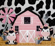 a pink barn with black and white cow standing next to it