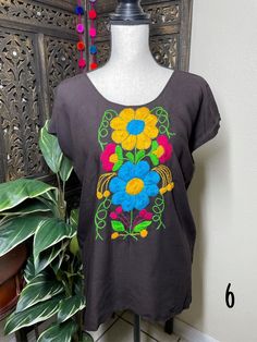 "A very nice and beautiful Sunflower Blouse w/Gorgeous Embroidery. The design work is simply gorgeous. Perfect for your ultimate weekend look, beach, casual look or just to impress your friends with this gorgeous piece. You will Love it! Blouse STYLE DETAILS Overview * Round neck * Handmade work * 3/4 Long sleeves * 22\" UNDERARM TO UNDERARM, 30.5\" SHOULDER TO HEM fabric & care * hand wash * delicate care * hang dry Please email me your questions before buying email me TODAY All of my items Summer Blouse With Floral Embroidery And Short Sleeves, Vacation Tops With Multicolor Floral Embroidery, Embroidered Folk Blouse For Beach, Folk Embroidered Beach Blouse, Folk Style Embroidered Beach Blouse, Summer Geometric Embroidery Tunic Top, Floral Embroidered Tunic Top For Summer, Black Floral Embroidered Blouse For The Beach, Summer Embroidered Tunic Blouse