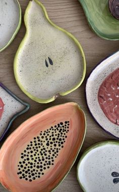 four ceramic bowls with different designs on them