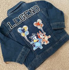 a denim jacket with cartoon characters on the back and name legend written on the front