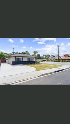 this is an image of a house on the street with palm trees in the background