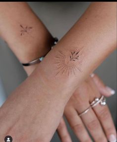 two women with matching tattoos on their arms