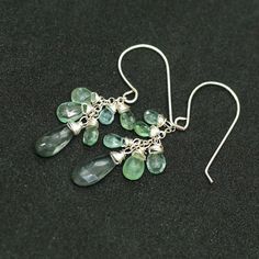 "Moss Aquamarine and Emerald Earrings A stunning Blue Moss Aquamarine beads accented with Emerald Briolette beads. The Briolette and The gems are wrapped with high quality sterling silver wire and swing from a sterling silver hook. These are natural, not colourd excellent AAA quality gems, beautifuly faceted and sparkling. An elegant and feminine, chic statement earrings, perfect for special occasion, wedding, holidays or as a Gift for Her. Mesurements: Moss Aquamarine Briolette : 0.75'' The ear Turquoise Apatite Gemstone Earrings, Sterling Silver Teardrop Chandelier Earrings With Gemstones, Sapphire Briolette Gemstone Earrings, Sterling Silver Dangle Earrings With Gemstone Accents, Turquoise Sterling Silver Earrings With Gemstone Accents, Nickel-free Apatite Dangle Jewelry, Sterling Silver Drop Earrings With Gemstone Accents, Silver Apatite Jewelry For Anniversary, Silver Apatite Dangle Earrings