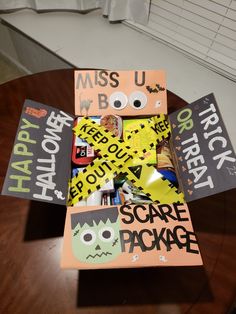 a table with some books on it and halloween stickers in the box next to it