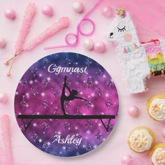 a clock with a girl doing gymnastics on it next to cupcakes