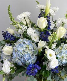 a vase filled with blue and white flowers