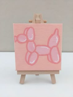 an easel with a pink poodle painted on it