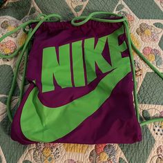 Bright Purple With Neon Green Nike Written. Different Than Most Bags As Zipper On Upper Left That Goes From One Side To Another! Never Used. Non Pet, Non Smoking Household Casual Purple Pouch Bag, Sporty Purple Gym Bag For Travel, Trendy Purple Bag With Dust Bag Included, Casual Purple Tote Bag, Purple Tote Bag For School, Purple Tote School Bag, Casual Purple School Bag, Purple Pouch Bag For School, Trendy Green Sports Bags