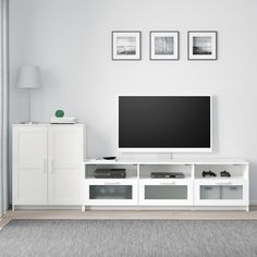 a flat screen tv sitting on top of a white entertainment center