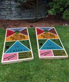 two cornhole game boards sitting in the grass