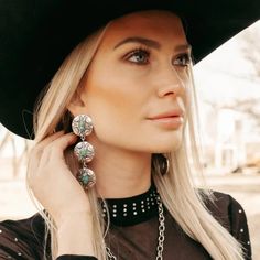 Add some Southwestern flare to your outfit with our Concho Valley Earrings! These silver dangle conchos feature a stunning turquoise stone that will make a statement wherever you go. Embrace your inner cowgirl and elevate your style with these unique earrings. Yeehaw! Shop Bourbon Cowgirl jewelry for spirited women. length - 3.5" Western Turquoise Jewelry, Southwestern Earrings, Turquoise Jewelry Outfit, Turquoise Jewelry Western, Rodeo Style, Western Turquoise, Double Piercing, Country Jewelry, Navajo Style