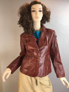 Vintage 70s Ox Blood Leather Blazer, says size 12 but fits much smaller than that. Excellent condition, one mark on lapel from pin or something but barely noticeable Shoulders 17.5 Chest 36 Inches Waist 33 Inches Nape to hem 22 Fitted Retro Vintage Brown Leather Jacket, Fitted Vintage Brown Retro Leather Jacket, Fitted Retro Brown Blazer, Vintage Leather Fitted Blazer, Vintage Single Button Blazer With Lapel Collar, Vintage Leather Jacket With Lapel Collar For Fall, Fitted Brown Blazer With Snap Buttons, Retro Single-breasted Leather Jacket For Fall, Retro Spring Leather Jacket For Workwear