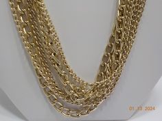 Vintage 52" gold tone chains necklace. Triple strands. Hinged clasp. Excellent vintage condition. Made in Japan. Gold Multi-strand Necklace With Adjustable Chain, Gold Multi-strand Costume Jewelry Necklace, Gold Multi-strand Figaro Chain Necklace, Gold Multi-strand Layered Necklace With Figaro Chain, Gold Multi-strand Chain Necklace, Gold Multi-strand Chain Necklace For Formal Events, Gold Multi-strand Chain Necklace For Formal Occasions, Formal Gold Multi-strand Layered Necklace, Metal Necklaces