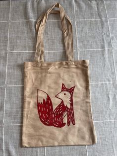 "Made To Order Fox Block Print Tote Bag Hand carved and made by me, each tote bag is unique and may vary. Each tote bag is made to order. Don't see a certain color you like? Just ask! I will be more than happy to work with you. MEASUREMENTS: Approximately 13\"x11\"  Thanks for visiting! If you have any questions, comments or are interested in commissions please don't hesitate to reach out. Follow @thesmilingoctopus on instagram!" Eco-friendly Hand Painted Bags For Daily Use, Eco-friendly Tote Bag For Crafting, Hand Printed Canvas Tote Bag - Ideal Gift, Hand Printed Canvas Tote Bag For Gift, Hand Printed Canvas Tote Bag Perfect For Gifts, Hand-printed Tote Bag For Daily Use, Hand Printed Canvas Tote Bag Ideal For Gifts, Hand Printed Tote Bag For Everyday Use, Hand Printed Tote Bag For Daily Use