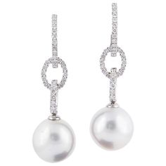 18K White gold drop earrings featuring two South Sea pearls measuring 11-12 mm and 68 round brilliants weighing 0.81 carats. Pearl Quality AAA Luster AAA, Excellent Nacre Very Thick White Gold Drop Earrings, Hoop Drop Earrings, Hoop Dangle Earrings, Golden South Sea Pearls, Sea Pearl, Diamond Drop Earrings, South Sea Pearls, Sea Pearls, Diamond Drops