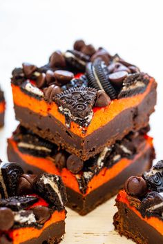 several pieces of cake are stacked on top of each other with cookies and oreos