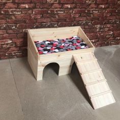 a child's wooden step stool with mickey mouse fabric on the top and bottom