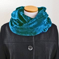 a black coat with a blue scarf on it