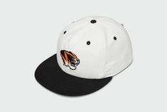 Introducing your new game day essential. Show your school spirit and represent the Mizzou Tigers with this versatile and stylish 90s white hat. Perfect for students, alumni, and fans alike. Made from all-natural, 100% cotton duck, this five panel hat is sure to keep your noggin cool and airy all summer long. 100% Duck Cotton Matching red undervisor Vintage Lightly Structured Fit Snap back closure Medium Crown One Size Fits Most Adults (6 7/8 to 7 3/4) Made in the USACut and Sewn in Kansas City, Throwback White Hat For Streetwear, White Snapback Hat For Fan Gear, White 5-panel Snapback Hat, Casual White Dad Hat With Flat Bill, White Baseball Cap For Game Day, White Collegiate Snapback Hat, White Sports Fan Baseball Cap For Game Day, Retro White Six-panel Trucker Hat, White Collegiate Cap