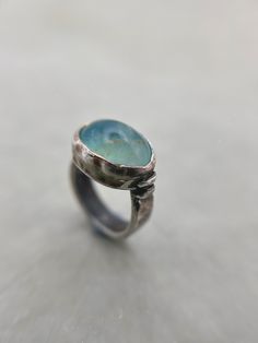 This listing is for a beautiful rare light aqua blue Andean Opal gem stone set into a chunky darkened sterling silver ring with a rustic finish for an earthy look. Opal is found and revered across the globe and can be found all over, from Canada to Ethiopia, Australia to Madagascar. But none are as rare and beautiful as the Andean Opals. These opals could only be found in Andean mountains in Peru.  Materials: Sterling silver 925 and fine silver 999, Andean blue Opal (Peru). Dimensions: Ring size Oval Aquamarine Fine Jewelry, Oval Aquamarine Light Blue Jewelry, Oval Light Blue Aquamarine Jewelry, Light Blue Oval Aquamarine Jewelry, Handmade Aquamarine Round Jewelry, Silver Aquamarine Jewelry With Natural Stones, Fine Jewelry Light Blue Gemstone, Blue Aquamarine Fine Jewelry, Spiritual Blue Topaz Jewelry In Blue