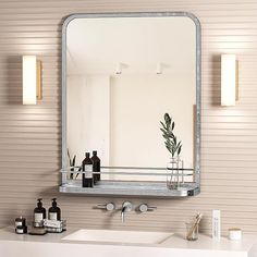 a bathroom with a sink, mirror and soap dispenser