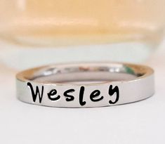 Petite name ring. Stacking name ring. Personalized name ring. This GOREOUS 3 mm ring is super shiny. Great for stacking. The surface is flat, so the lettering really stands out! Add names, initials, dates, quotes, roman numerals or scripture. I have the heart, double heart, infinity, #, &, @, !, =, *, :, ?, cross, baby foot, angel, and ribbon stamps. 15-character limit. Made of solid surgical Stainless steel which will never rust, tarnish, change color and is hypoallergenic. Swim & shower safe! Trendy Personalized Rings For Everyday, Trendy Personalized Everyday Rings, Everyday Stackable Rings With Custom Name, Trendy Stackable Rings For Anniversary, Custom Name Adjustable Initial Ring For Promise, Minimalist Customizable Initial Ring For Promise, Trendy Personalized Promise Ring, Trendy Personalized Rings For Promise, Minimalist Customizable Initial Ring