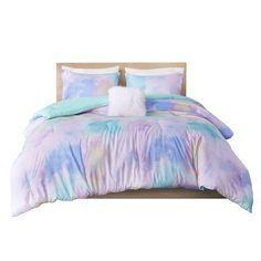 a bed with blue and purple comforters on it