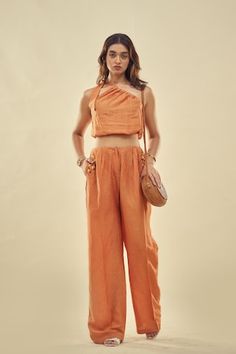 Orange one-shoulder crop top with a tie-up. Paired with a matching pant with embroidery around the pockets. - Aza Fashions Chic One-shoulder Summer Set, Chic One Shoulder Summer Sets, Chic Summer Cotton Pant Set, Chic Cropped Pant Set For Summer, Crop Top And Trouser, Pant Sets, Shoulder Crop Top, Set Women, Set For Women