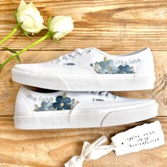 Fresh all white Vans Authentic trainers delicately hand embroidered with bold, bright flowers and finished with a name, date, initials or words of your choice. This design can be embroidered in any colour scheme you choose, please leave a note during checkout with any specific requests. Each pair is hand made to order and stitched with high quality embroidery thread which is washable and fade resistant.  If you're looking for something a little more bespoke, I offer a limited number of fully custom hand embroidered trainers tailored to your wishes. Consider your wedding theme, your favourite flowers, your bouquet and more all tailored to your budget. We can work together to create something perfect for you. Check out my Etsy store for the 'custom order' listing, please read item descriptio White Cotton Sneakers With Floral Embroidery, White Casual Sneakers For Wedding, White Casual Wedding Sneakers, White Low-top Sneakers With Floral Embroidery, White Floral Embroidery Low-top Sneakers, White Floral Embroidered Low-top Sneakers, White Vans Authentic, All White Vans, Wedding Vans