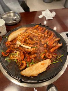 a pan filled with food sitting on top of a table