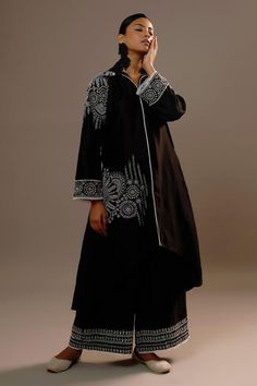 Black full sleeves long kurta in summer silk base with mughal bloom embroidery and collared neckline. Paired with matching flared palazzo.
Components: 2
Pattern: Embroidery
Type Of Work: Floral Bloom
Neckline: Collar
Sleeve Type: Full
Fabric: Summer Silk
Color: Black
Other Details: 
Attached inner lining
Length:
Kurta: 35inches(front), 46inches(back)
Palazzo: 38inches
Occasion: Sangeet, Mehendi and Haldi - Aza Fashions Semi-stitched Long Sleeve Kaftan With Dabka Work, Long Sleeve Semi-stitched Kaftan With Dabka Work, Elegant Abaya With Dupatta, Silk Palazzo Set With Chikankari Embroidery And Long Sleeves, Silk Long Sleeve Palazzo Set With Chikankari Embroidery, Bohemian Long Sleeve Embroidered Palazzo Set, Elegant Long Sleeve Palazzo Set For Transitional Season, Transitional Anarkali Kaftan With Long Sleeves, Designer Long Sleeve Kaftan With Dupatta