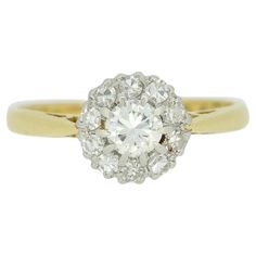 an old mine cut diamond cluster ring in 18ct yellow gold, set with round brilliant diamonds