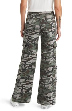 Give in to your style nostalgia and throw it back to Y2K in a pair of wide-leg cargo pants cut from a stretchy cotton blend patterned with classic camo. 32" inseam; 25 1/2" leg opening; 10" front rise; 15" back rise 97% cotton, 3% spandex Machine wash, tumble dry Imported Camouflage Wide Leg Cargo Bottoms, Military Wide Leg Cargo Bottoms, Full Length Camouflage Bottoms With Cargo Pockets, Military Style Wide Leg Cargo Bottoms, Relaxed Fit Wide Leg Military Cargo Jeans, Military Cargo Style Wide Leg Bottoms, Casual Camouflage Cargo Jeans, Casual Full-length Camouflage Cargo Jeans, Utility Wide Leg Camouflage Pants