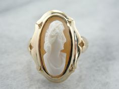 This vintage ladies ring features the well-carved profile of a matron of Ancient Rome. The shell is deep, rich brown and the portrait is a clean white. Cameo is the art of carving a layered material, creating a portrait or landscape in the differing colors and textures. Shell is the traditional medium for this artwork. Metal: 10 Karat Yellow Gold Gem: Natural Shell Cameo Gem measurements: 18 x 10 mm, Oval Size of Ring: 6, This ring can be sized. Please convo for details. Each piece has been iden Cameo Ring, Vintage Cameo, Ladies Ring, Carved Shell, Oval Ring, Oval Rings, Gold Gift, Ancient Rome, Jewelry Companies