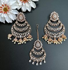 This Set comes with Maangtikka and matching earrings and in 3 beautiful pastel colors. Extremely high quality stones and handwork for a beautiful elegant look. This lightweight and elegant Maangtikka set is perfect for any bridesmaid, bride, sangeet or any occasion or event as a gift for any occasion as any one who loves jewelry will love this statement piece. It has beautiful colors that really make the set a statement piece. Product Details: • Tikka/Headpiece • Earrings Free Shipping/Ready to Luxury Multicolor Festive Jhumkas, Luxury Meenakari Tikka For Festive Season, Elegant Chandbali Tikka, Traditional Rose Gold Jewelry Sets Hand Set, Traditional Rose Gold Hand Set Jewelry Sets, Elegant Rose Gold Earrings For Festive Occasions, Elegant Party Tikka With Hand Set Details, Elegant Rose Gold Festive Earrings, Elegant Festive Rose Gold Earrings