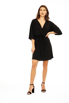 Product Details: Kimono style- flare sleeves Self tie at waist Dress length: falls above knee Color: solid black Signature stretch ITY fabric Machine wash cold, tumble dry low. Follow care label, instructions may vary by fabric. Made in USA of imported fabric Model height: 5 foot 8 inches Model is wearing a size XS Kimono Style Dress, Black Kimono, Flare Sleeves, Kimono Style, Care Label, Kimono Fashion, Waist Dress, Black Fits, Flared Sleeves