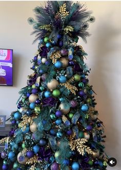 a decorated christmas tree with blue and green ornaments