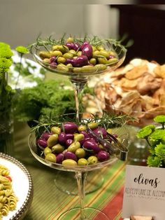 three tiered trays filled with different types of food on top of a table