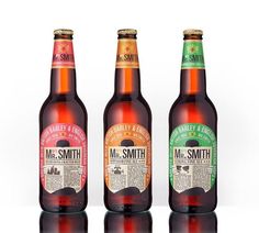 three bottles of mr smith beer on a reflective surface