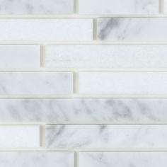 a white marble tile wall that looks like it has been cleaned