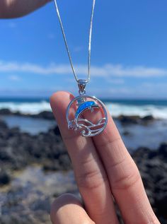 Pendant size: 22mm Meet our Blue Opal Dolphin Necklace, part of the Kauai Spinner Dolphin Collection. This necklace was inspired by the majestic spinner dolphins that inhabit the waters north of Kauai, particularly off the Na Pali Coast. Known for their acrobatic displays and vibrant presence, these dolphins bring joy and wonder to all who see them. The Blue Opal Dolphin Necklace celebrates the spirit of these incredible creatures and the natural beauty of their ocean home. Features: *Material: Spinner Dolphin, Na Pali Coast, Ocean Home, Ocean Inspired Jewelry, Dolphin Necklace, Incredible Creatures, Ocean Inspiration, Opal Necklace, Necklace Sterling Silver