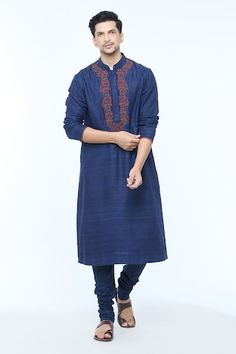 Navy blue full sleeves handloom silk kurta with floral vine embroidery near the placket. Paired with a churidar. - Aza Fashions Indigo Traditional Wear With Chikankari Embroidery And Long Sleeves, Long Sleeve Slub Silk Sherwani For Festivals, Festival Long Sleeve Slub Silk Sherwani, Long Sleeve Embroidered Slub Silk Traditional Wear, Tussar Silk Long Sleeve Traditional Wear With Chikankari Embroidery, Ceremonial Cotton Silk Kurta With Long Sleeves, Long Sleeve Slub Silk Sherwani For Eid, Ceremonial Long Sleeve Cotton Silk Kurta, Ceremonial Long-sleeve Cotton Silk Kurta