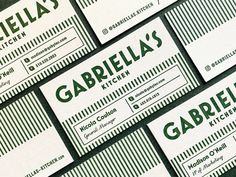 several business cards are stacked on top of each other in green and white letters that spell out the names of their businesses