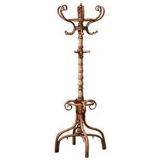 an ornate wooden coat rack with three candles on the top and one candle in the middle