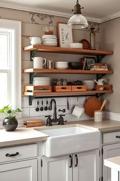 A cozy kitchen with open wooden shelves holding dishes, plants, and kitchenware above a farmhouse sink. Chic Farmhouse Kitchen, Modern Farmhouse Kitchen Ideas, Stylish Farmhouse, Rustic Wooden Shelves