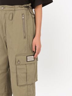 Khaki green cotton knee-length cargo shorts from DOLCE & GABBANA featuring logo plaque, frayed edge, mid-rise, button fly fastening, drawstring fastening waist, two side zip-fastening pockets, two side flap pockets, two rear zip-fastening pockets and knee-length. | Dolce & Gabbana Knee-Length Cargo Shorts Knee Length Shorts, Cotton Logo, Khaki Green, Green Cotton, Flap Pocket, Cargo Shorts, White Shorts, Unique Style, Mid Rise