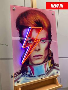 a neon sign with the image of david stewart on it's face and lightning bolt