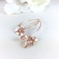 "Gold Earrings, Silver Earrings, Orchid Flower Earrings, Long Dangle Earrings, Wedding Jewelry, Bridesmaid Gift, Bridal Earrings, Gift for Her, Gift for Mom, Sister, Friend Simply and dainty, these earrings are composed of a matte gold/rose/silver plated orchid flower dangling from long gold/silver/rose tone copper ear wires. Dangle length is 2\" (58mm) from top of ear wire. Flower measures 21x15mm Discount for multiple (3 pair or more) bridal party orders. CUSTOM REQUESTS ARE ALWAYS WELCOMED! ● Delicate Dangle Flower Earrings For Bridesmaids, Delicate Drop Flower Earrings For Bridesmaid Gift, Delicate Adjustable Flower Earrings For Wedding, Delicate Flower Earrings For Bridesmaid Gift, Minimalist Rose Gold Hoop Earrings For Wedding, Minimalist Wedding Earrings In Flower Shape, Minimalist Flower Shaped Wedding Earrings, Minimalist Wedding Flower Earrings, Minimalist Matching Flower Earrings For Wedding